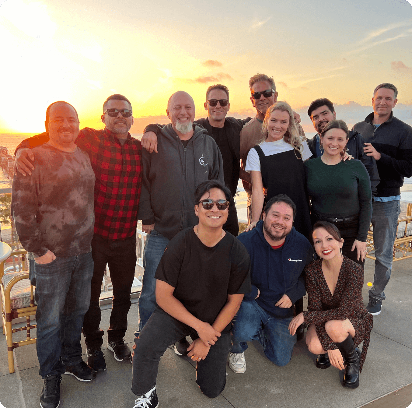 Group of Havas Edge employees standing in front of a sunset