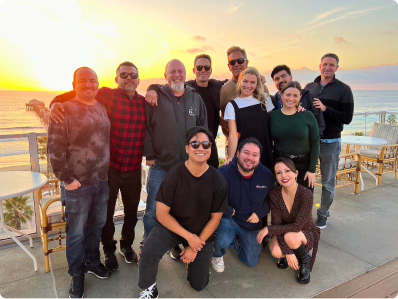 Group of Havas Edge employees standing in front of a sunset