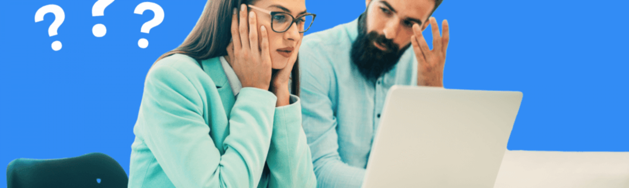 A man and a woman sitting behind a laptop looking confused and frustrated.