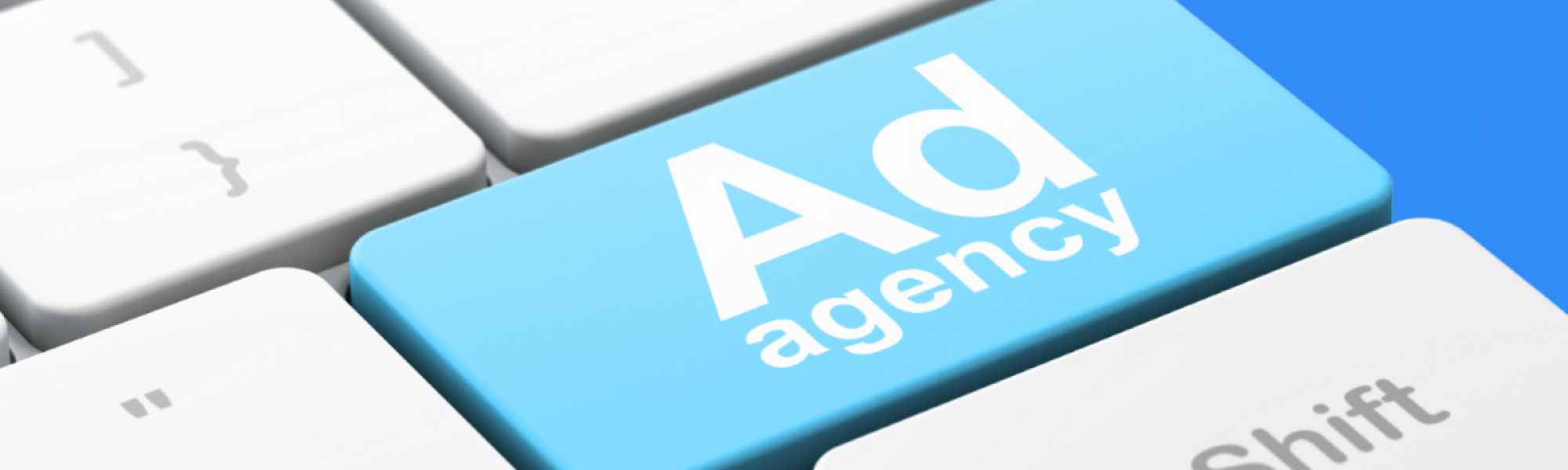 Keyboard with a blue button that reads, "Ad agency."